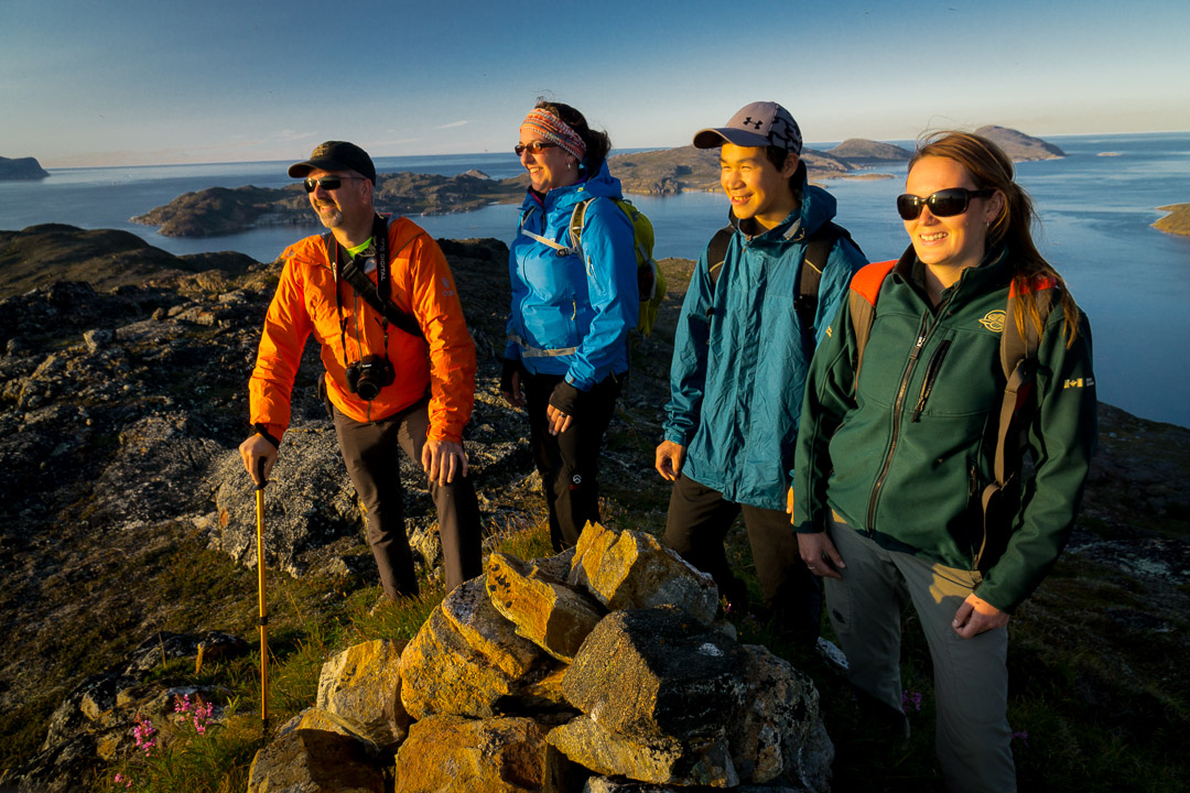 Randy Letto, Janice Goudie, Jonathan Lidd and Jenna Andersen bask in alpenglow on a heli hike on ridges above Torngat Mountains Base Camp and Research Station, Northern Labrador Mountains, (Newfoundland and Labrador), Canada hike