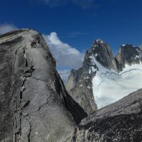 On their way to the top of Pigeon Spire, with dramatic backdrop of Howser Spires during the Bugaboos Teens 2013 climbing camp organized by the Conrad Kain Centennial Society.