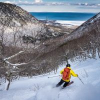 Gregor Wilson drops into French Gulch, Cape North, Cape Breton Island, Nova Scotia adventure ski shoot for Ski Canada magazine.