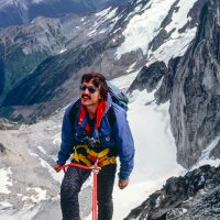 Pat Morrow rappels from Bugaboo spire, on climb with Indonesian climbing friends Adiseno, etc, Purcell Range, c 1986.