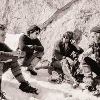 Rob Wood, George Homer, Brian Greenwood and Jon Jones at base of Iron Suspender slowly working on its first ascent, CMC Valley, Rockies near Calgary AB c1970 Calgary Mountain Club