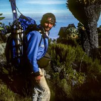 Pat Morrow carries his Karhu telly skies on way to ski inside the summit caldera on Mt Kilimanjaro. 1983